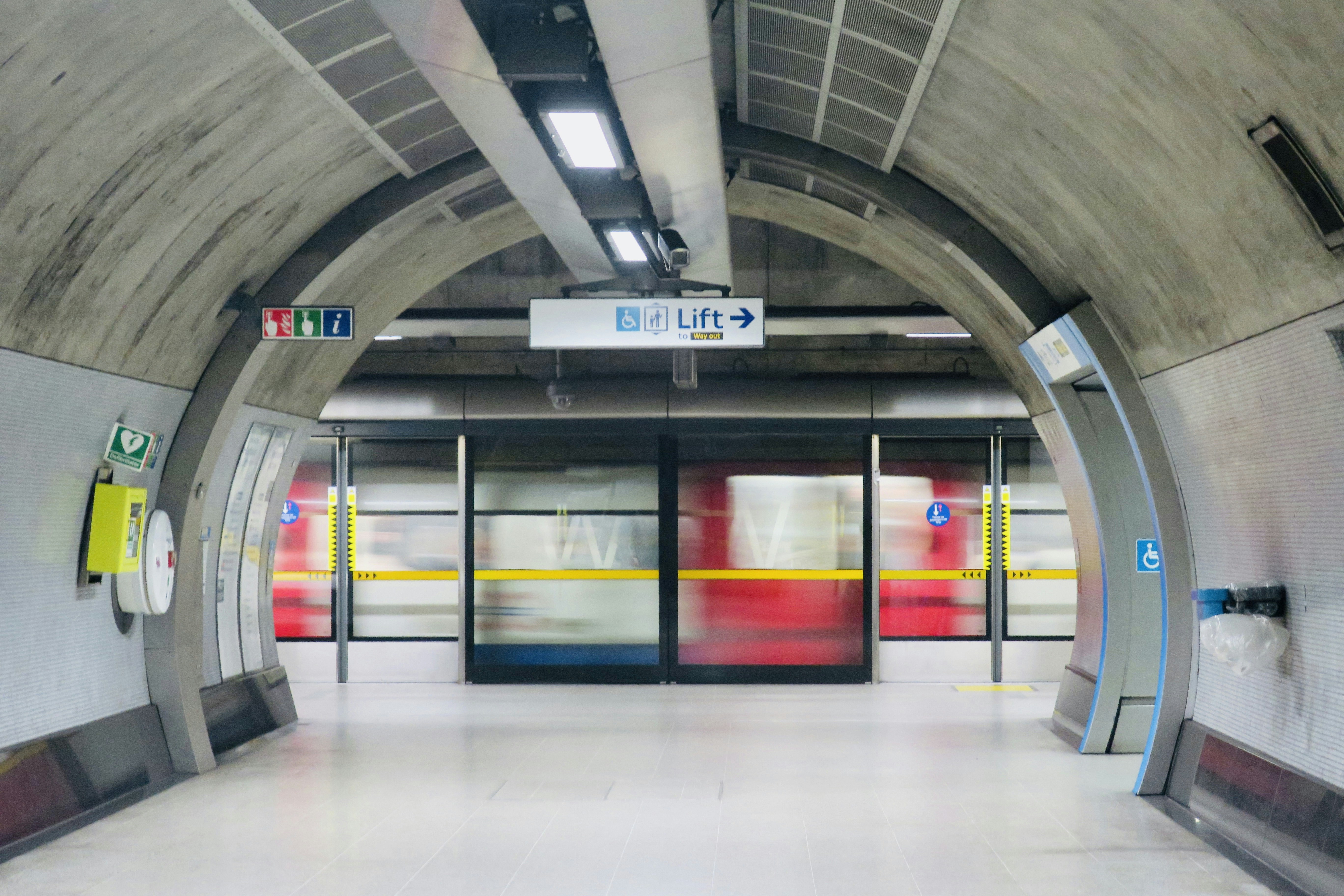 a subway station with doors and a sign on the wall