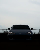 Dynamic angle of a sports car with glowing headlights on a black background