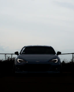 Dynamic angle of a sports car with glowing headlights on a black background