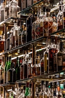 Various spirits and liquors arranged neatly on backlit shelves