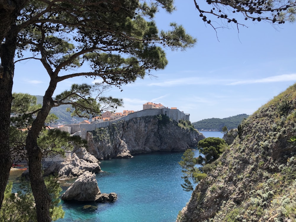 a body of water with a castle in the background