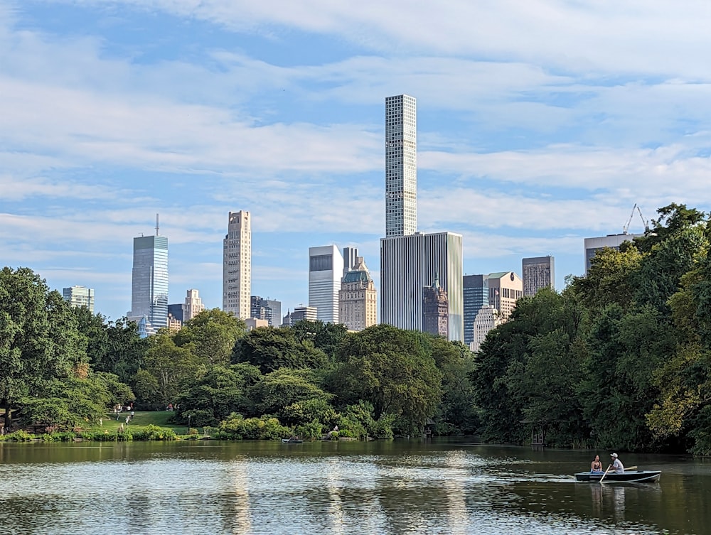 a man in a boat on a river in a city park