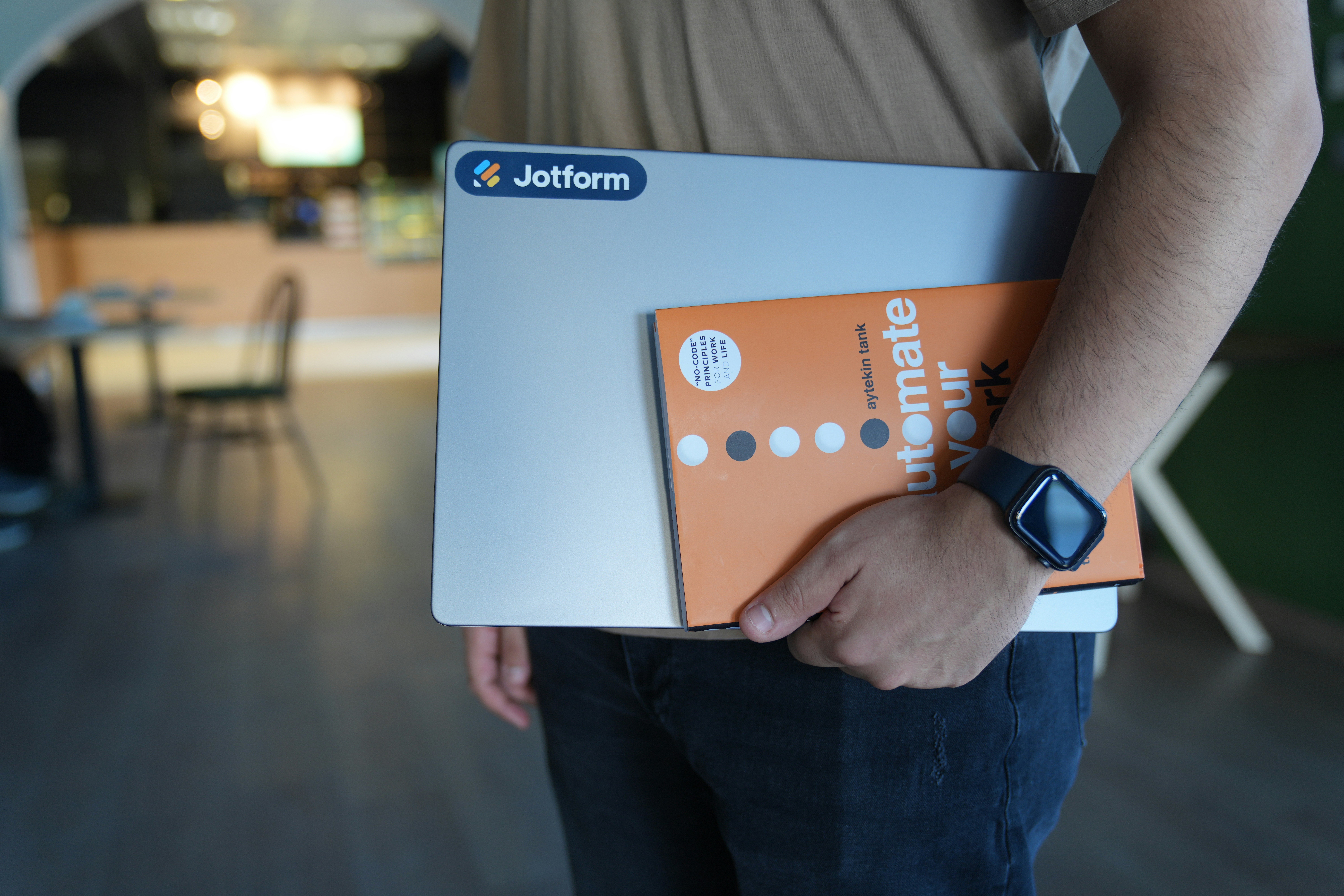 a man holding a laptop computer in his hands