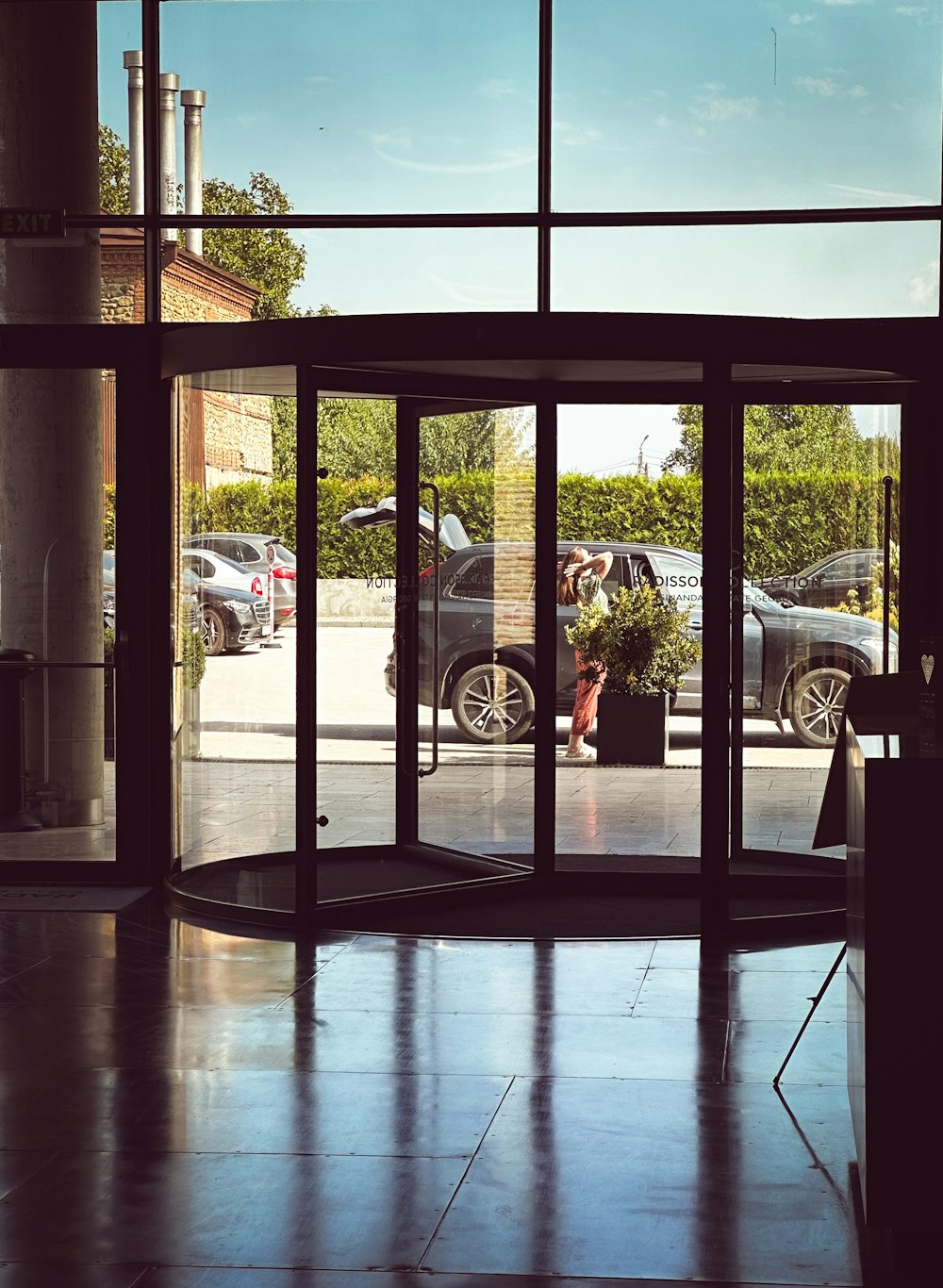 a car is seen through a glass door