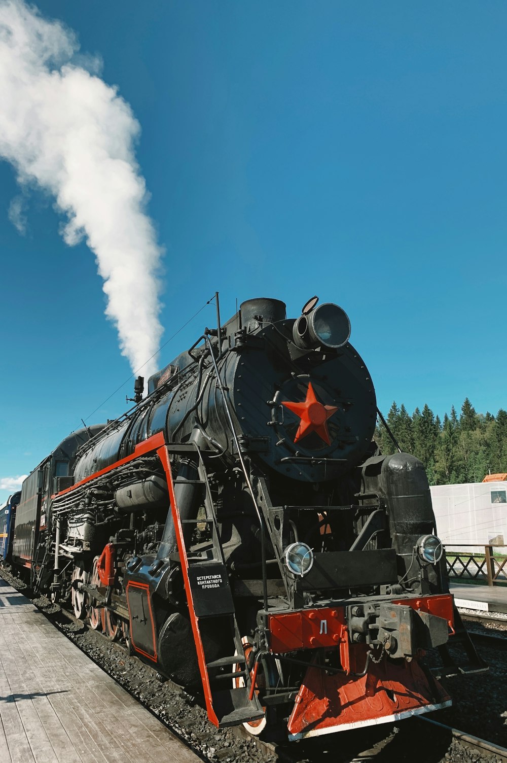 a black and red train traveling down train tracks