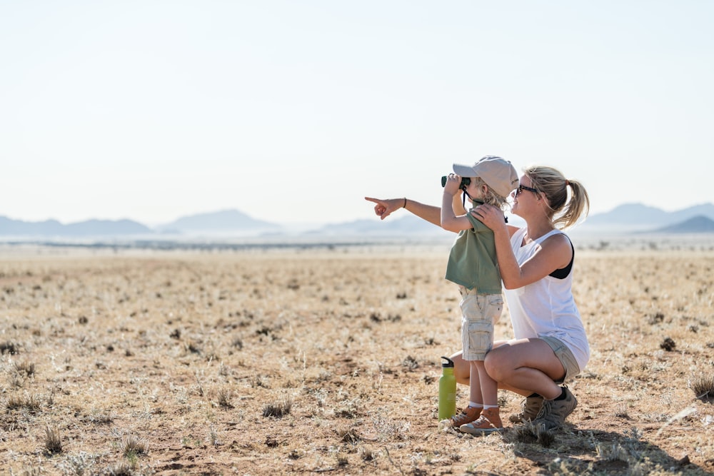 a woman taking a picture of a child with a camera