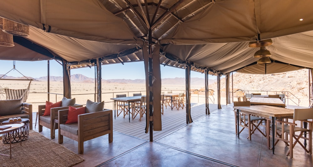 a covered patio with a table and chairs