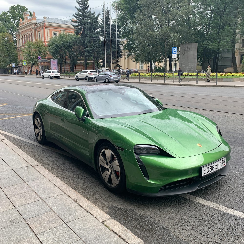 a green sports car parked on the side of the road