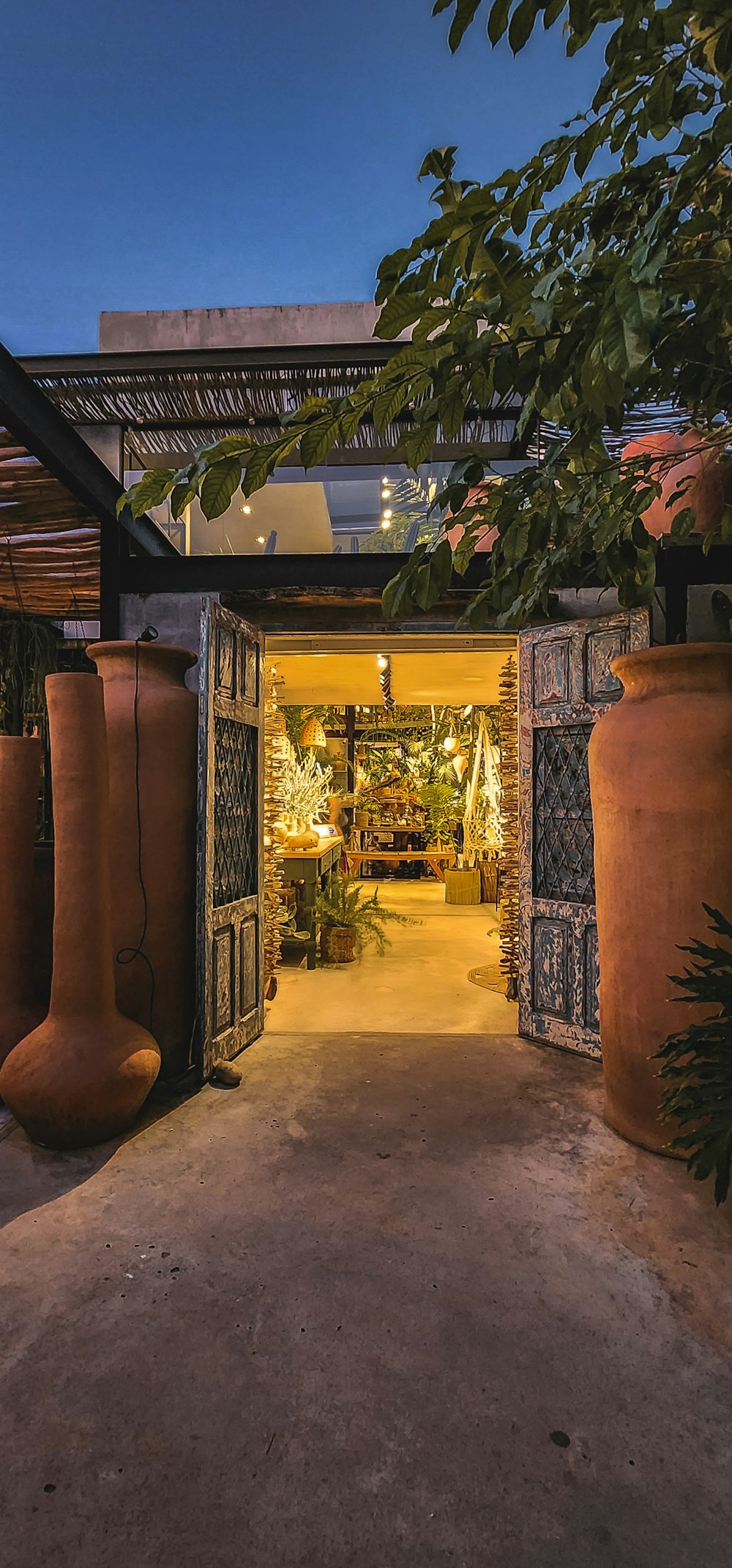 an entrance to a building with large vases