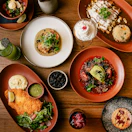 a wooden table topped with plates of food