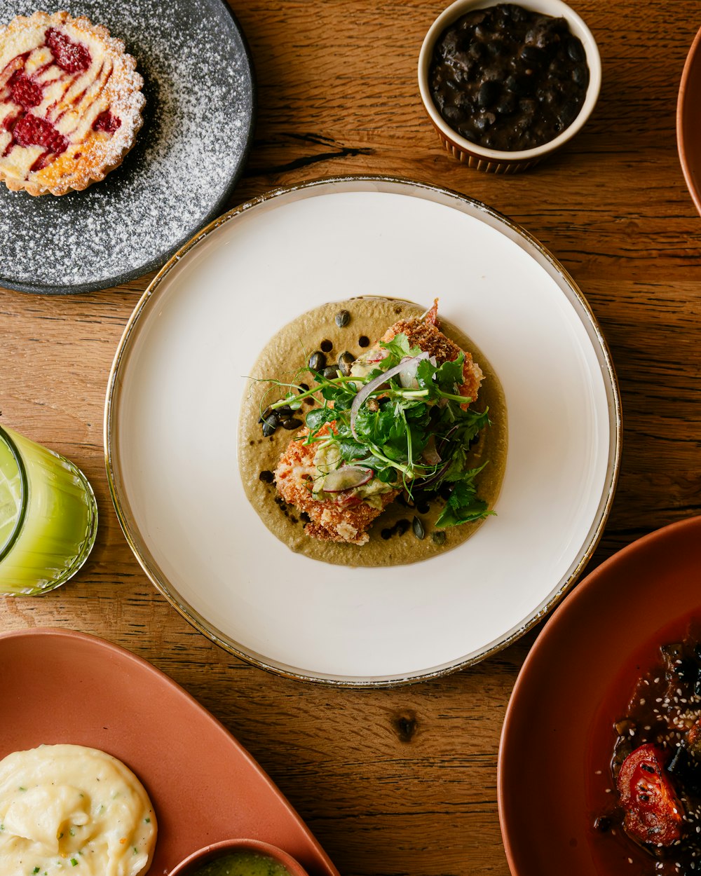 a table topped with plates and bowls of food