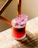 Close-up of a vibrant red velvet mocktail with fresh garnish on a wooden table.