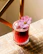 Close-up of a vibrant red velvet mocktail with fresh garnish on a wooden table.