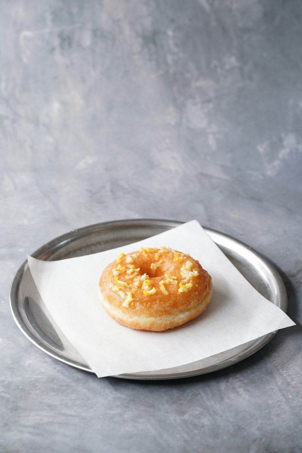 a donut sitting on top of a metal tray