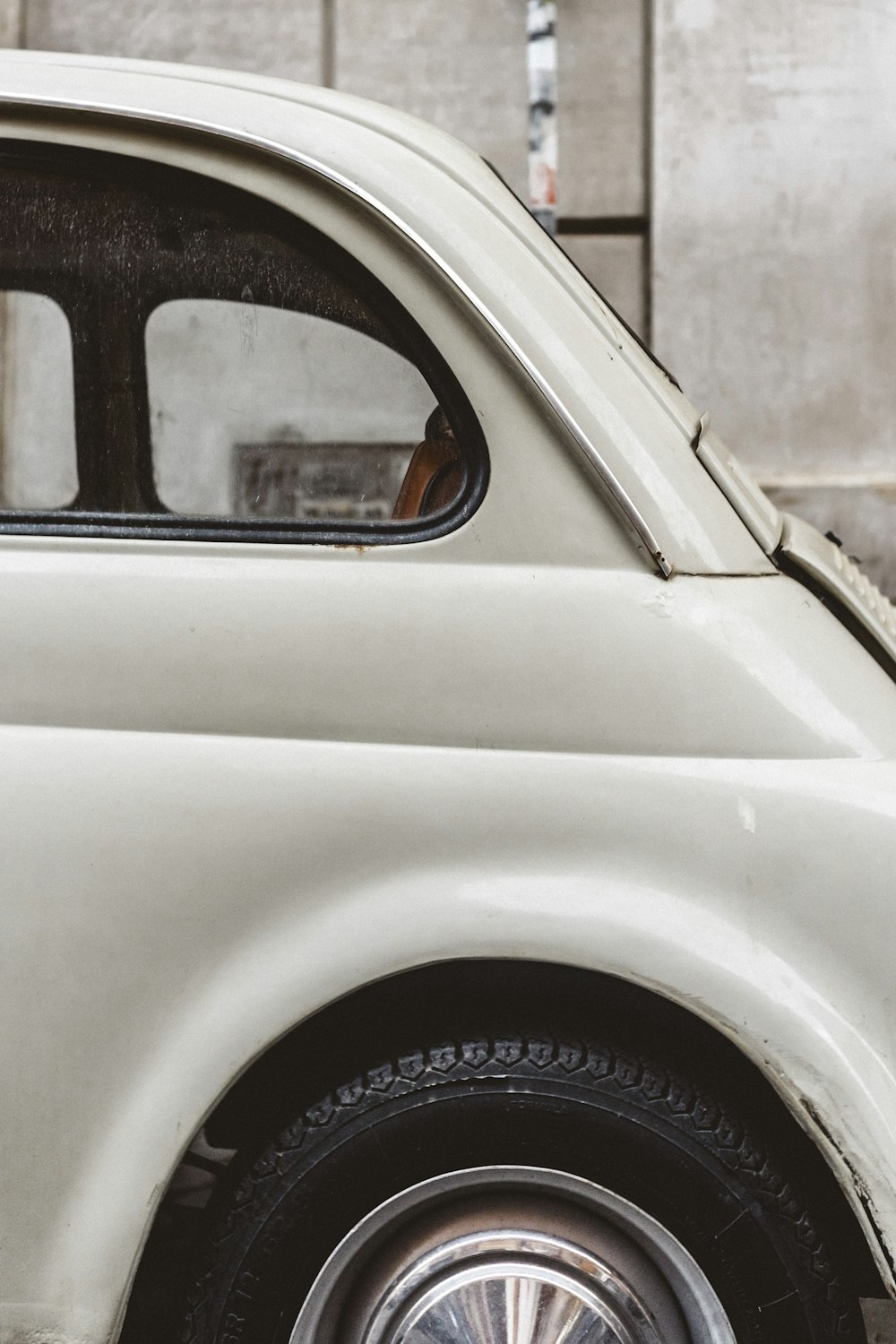 a small white car parked in front of a building