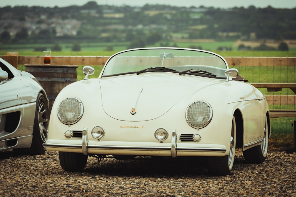 a white sports car parked next to a silver sports car