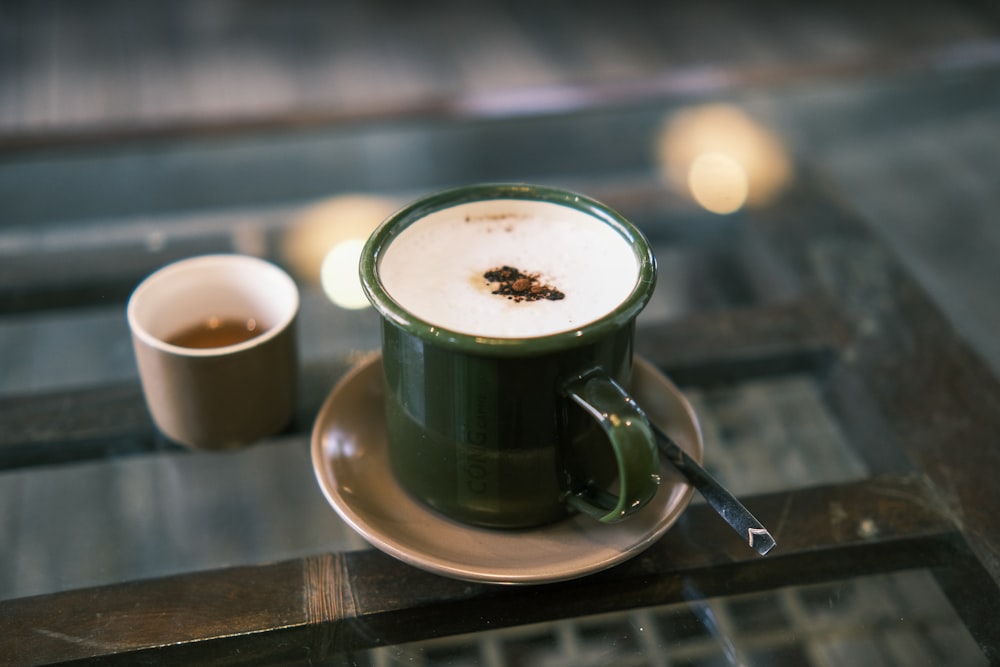 a cup of coffee and a spoon on a table