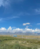 A comfortable bus winding through scenic desert landscapes under a clear sky