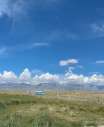 A long-distance coach traveling on a highway through scenic landscape.