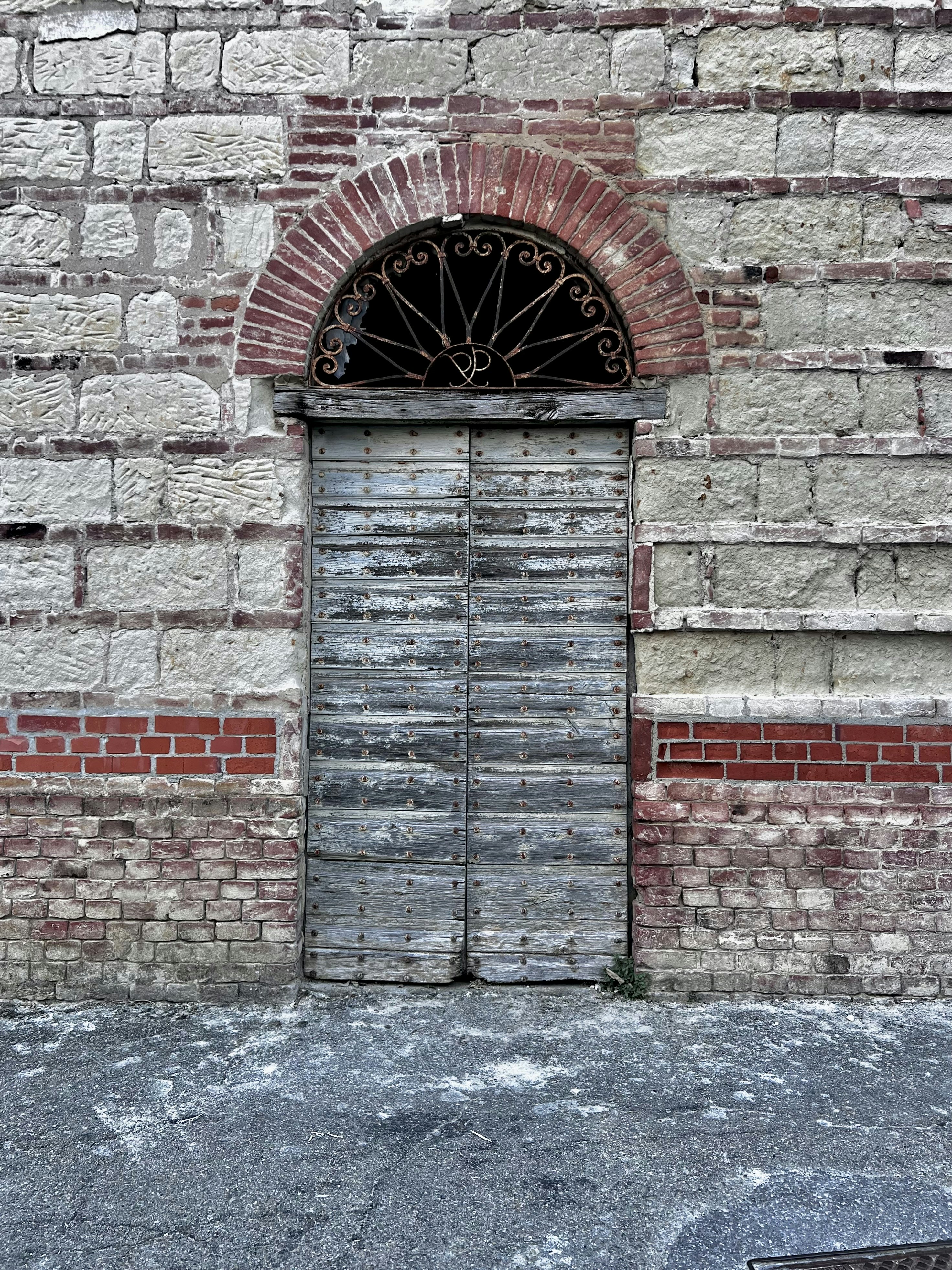 an old brick building with a door and window