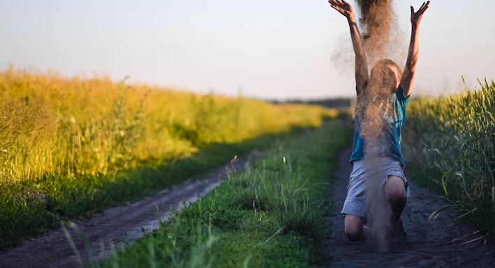 a Child walking next to a field