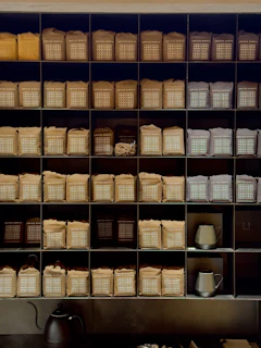 Rows of Black Gates Coffee Co. bags lined up on a shelf, ready for shipment.
