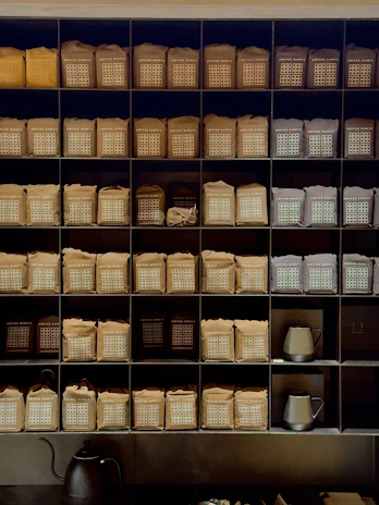 Rows of Black Gates Coffee Co. bags lined up on a shelf, ready for shipment.