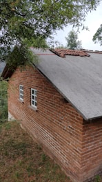 a red brick building with a white window