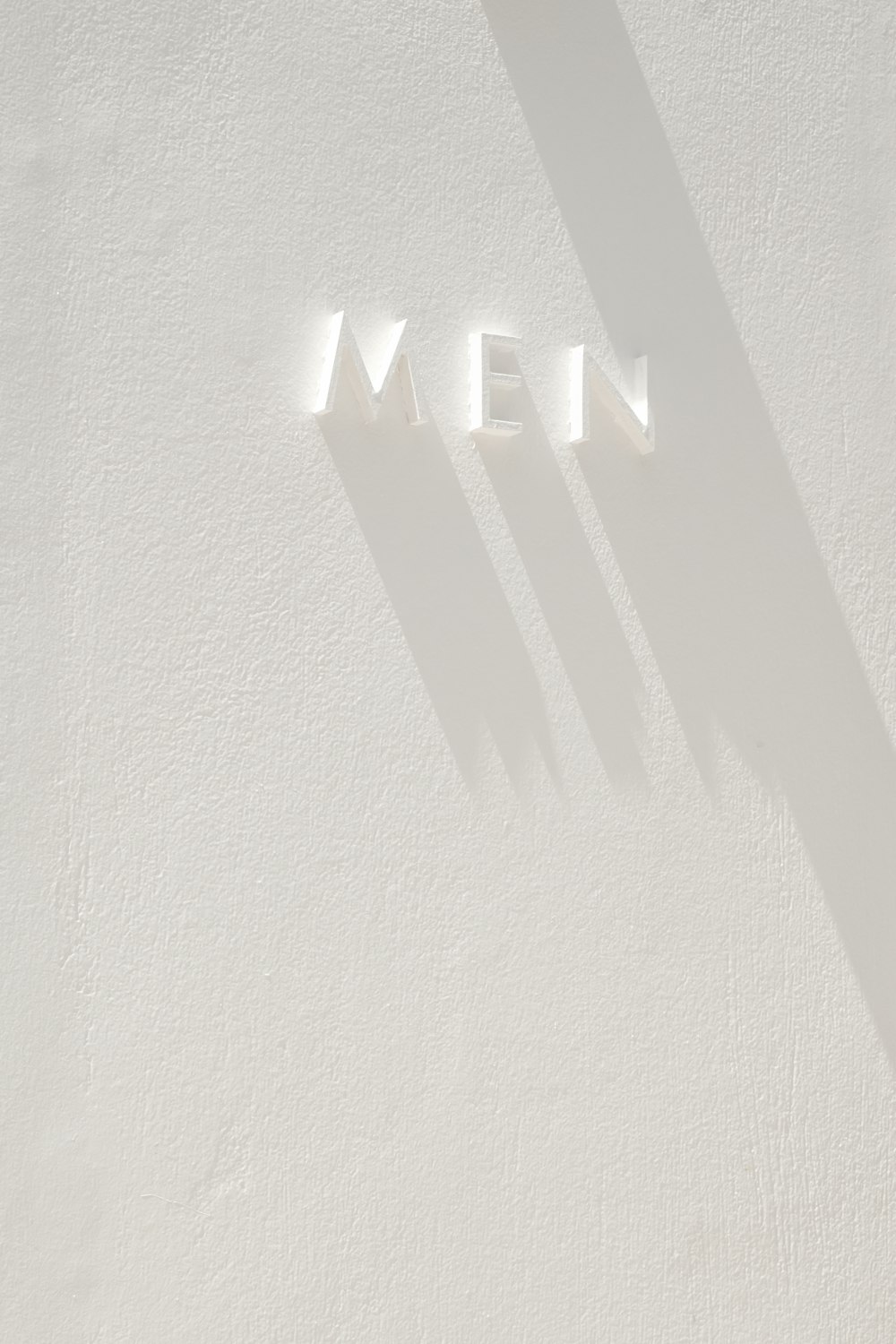 a white wall with the word mean written on it