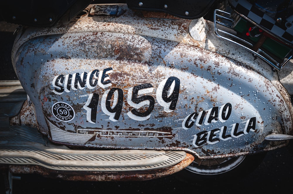a close up of an old motorcycle with rust