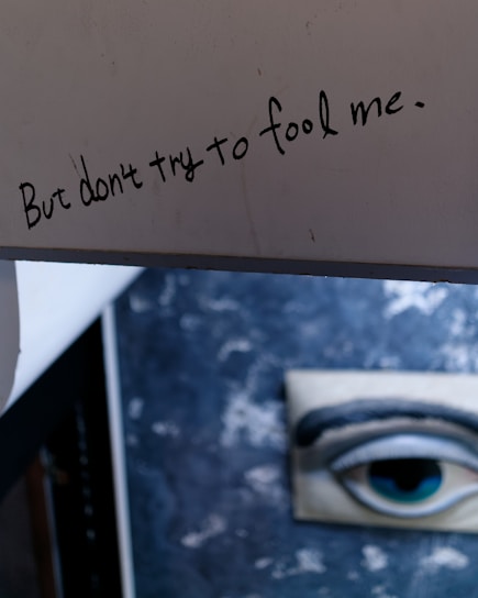 A close-up photo of a handwritten note warning about a scam company.