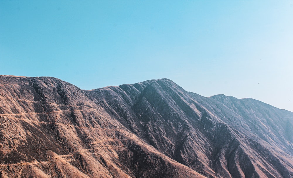 a view of a mountain range from the top of a hill