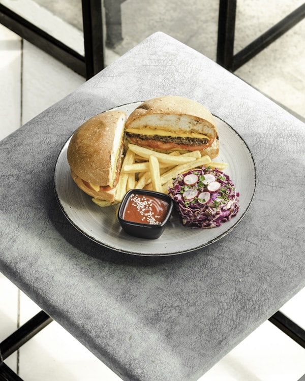 A plate with a sandwich and french fries on it