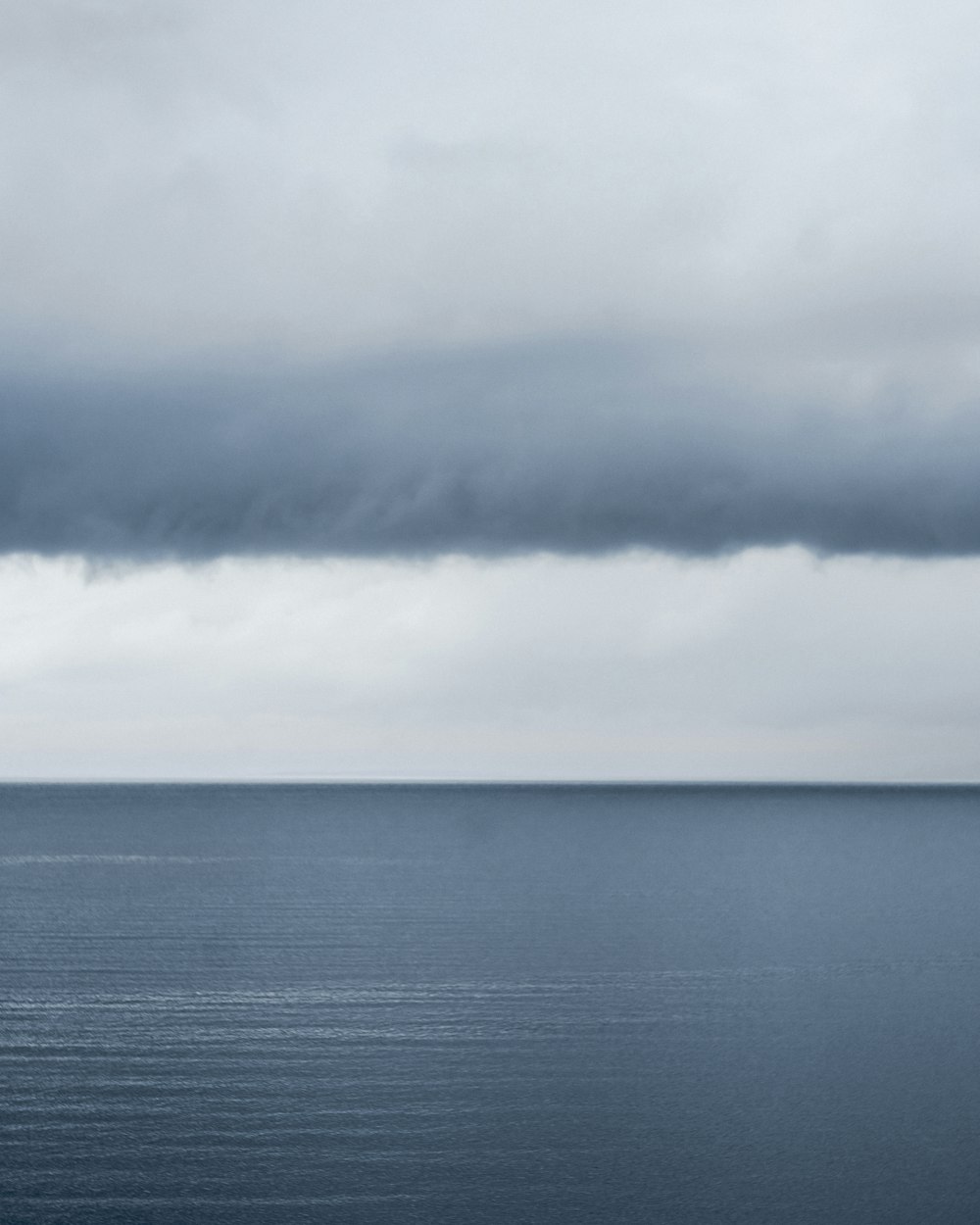 a large body of water under a cloudy sky