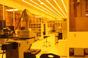 Modern microscopes lined up in a bright laboratory setting