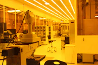 Photo of a modern lab setup with blue lighting and white scientific instruments emphasizing precision