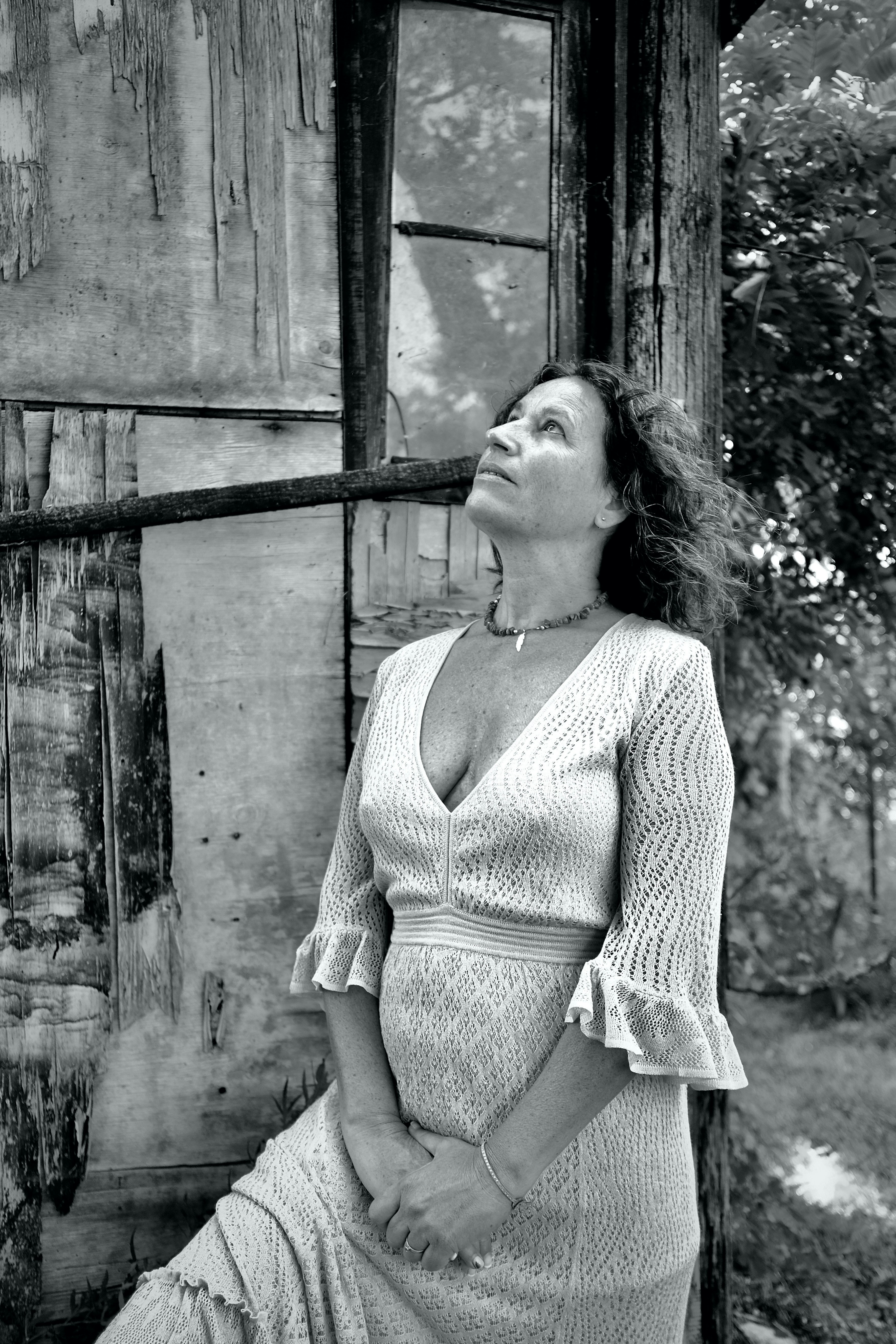 a black and white photo of a woman in a dress