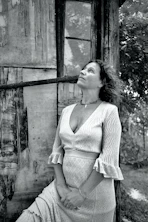 a black and white photo of a woman in a dress