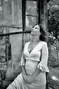 a black and white photo of a woman in a dress