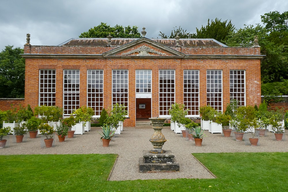 a brick building with a fountain in front of it