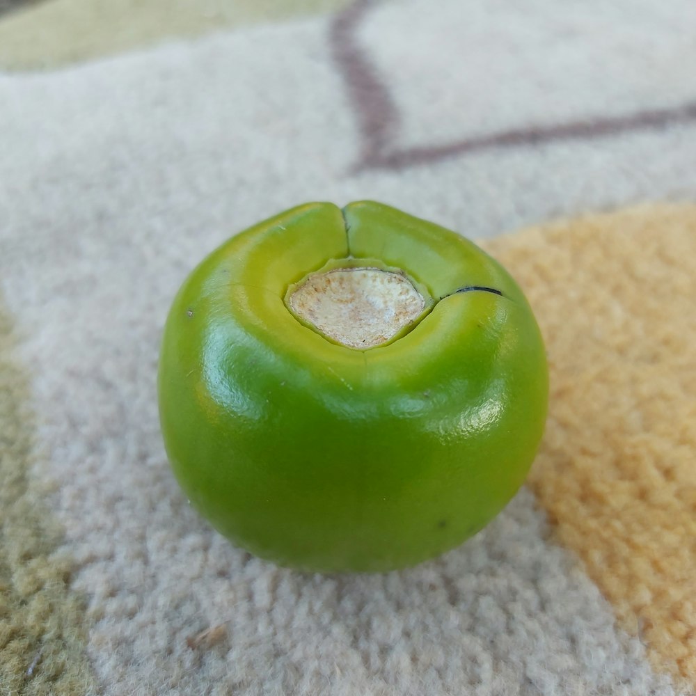 a green pepper sitting on top of a rug