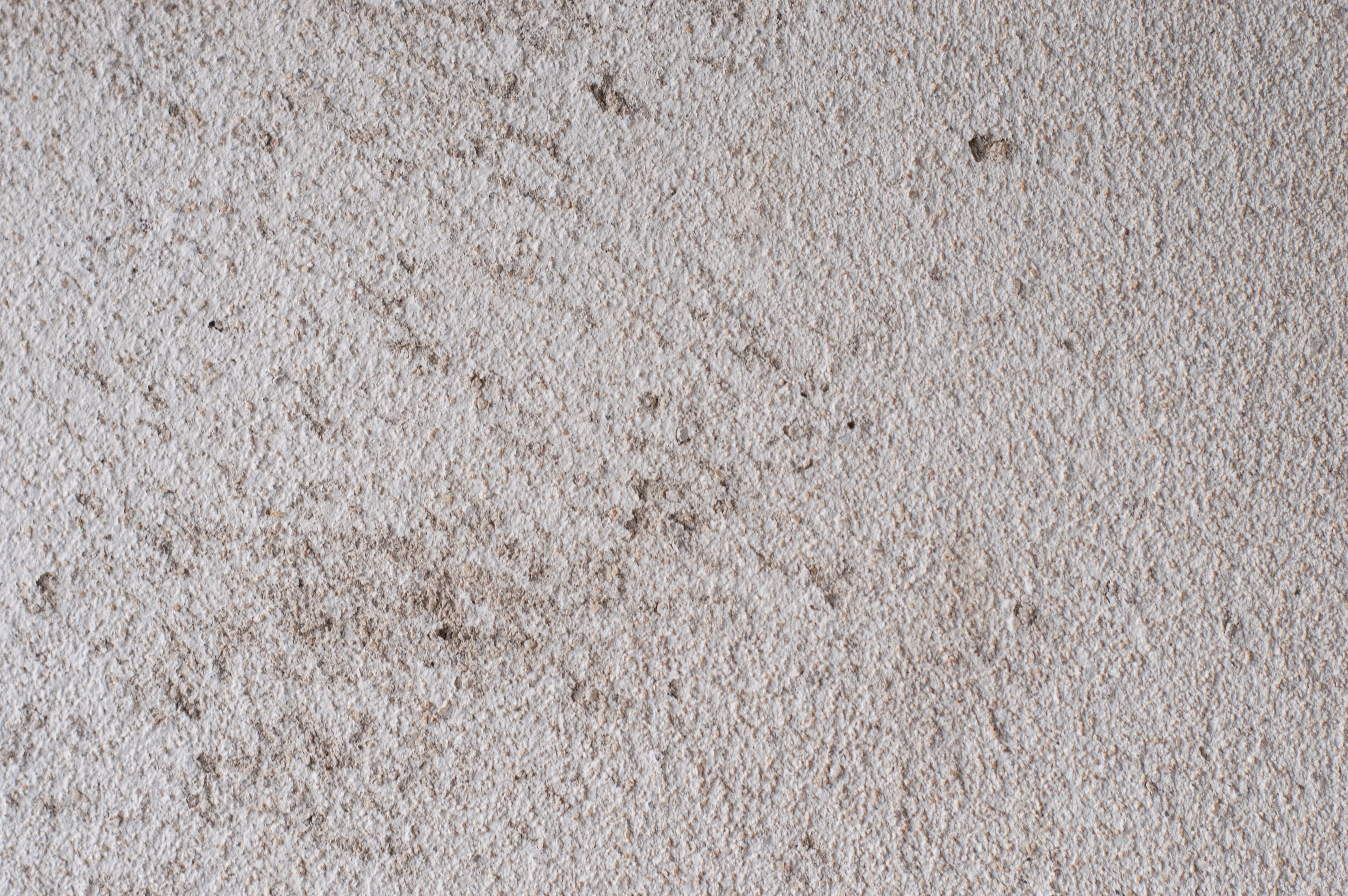a close up of a white carpet with brown stains