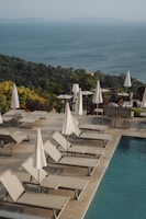 a group of lounge chairs sitting next to a swimming pool