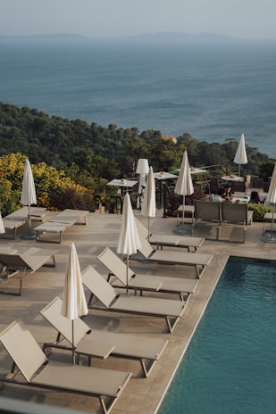 A serene poolside view with comfortable lounge chairs.