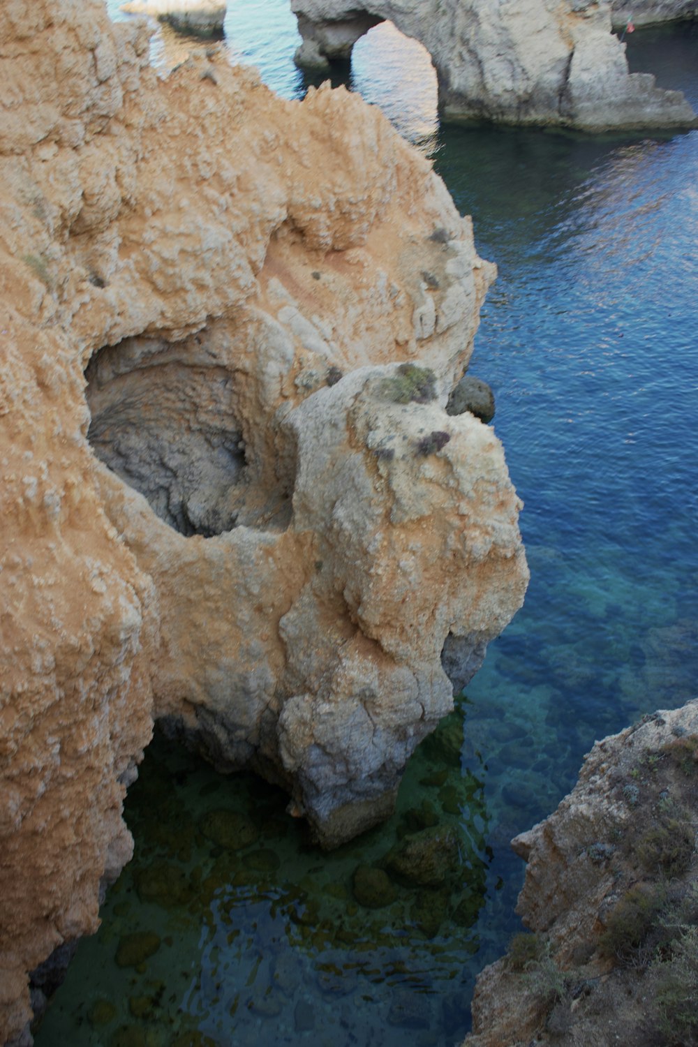 a body of water surrounded by large rocks