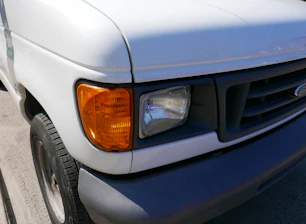 a close up of the front of a white truck
