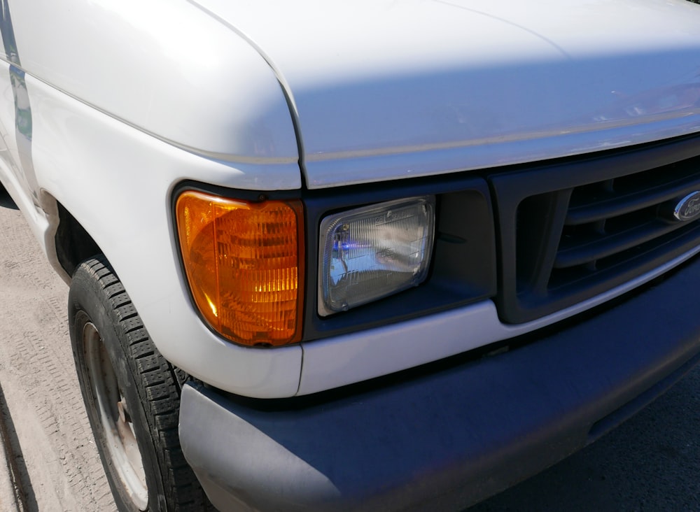 a close up of the front of a white truck