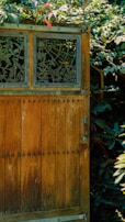 Close-up of a rustic wooden gate opening to a private finca garden.