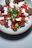 A close-up of a colorful Mediterranean salad with olives, tomatoes, and feta cheese.
