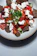 A close-up of a colorful Mediterranean salad with olives, tomatoes, and feta cheese.